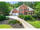 Beautiful brick home with a well-maintained lawn and mature landscaping at 542 Fairway Dr, Woodstock, GA 30189
