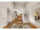 Elegant foyer with hardwood floors, a staircase, and views into other rooms at 542 Fairway Dr, Woodstock, GA 30189