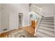 Spacious foyer with neutral walls, hardwood floors, and a staircase at 542 Fairway Dr, Woodstock, GA 30189