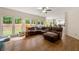 Open concept living room features a leather sectional sofa and large windows at 542 Fairway Dr, Woodstock, GA 30189