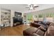 Spacious living room features a fireplace, ceiling fan and built-in shelving at 542 Fairway Dr, Woodstock, GA 30189