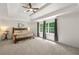 Bright and airy main bedroom features plush carpeting and trey ceiling at 542 Fairway Dr, Woodstock, GA 30189