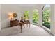 Bright home office with large windows, a desk, and neutral carpet at 542 Fairway Dr, Woodstock, GA 30189