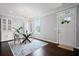 Cozy dining room featuring a glass-top table, stylish chairs, a chandelier, and hardwood floors at 149 Archie Way, Woodstock, GA 30188
