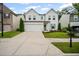 Beautiful two-story home with a two-car garage, green door and shutters, and a green lawn at 149 Archie Way, Woodstock, GA 30188