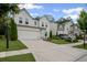 A traditional home with white siding, an attached two-car garage, a green lawn, and a paved driveway at 149 Archie Way, Woodstock, GA 30188