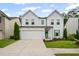 Charming two-story home featuring white siding, green shutters and door, plus a well-manicured lawn at 149 Archie Way, Woodstock, GA 30188