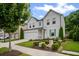 Attractive home with white siding, a well-maintained lawn, green door and shutter accents, and mature trees at 149 Archie Way, Woodstock, GA 30188