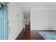Bright foyer with hardwood floors, gray walls with white trim, and a glimpse into the living spaces at 149 Archie Way, Woodstock, GA 30188