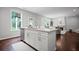 Open kitchen with island, seamlessly connected to the living area at 149 Archie Way, Woodstock, GA 30188