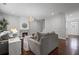 Spacious living room with a stone fireplace, comfortable seating, and elegant lighting at 149 Archie Way, Woodstock, GA 30188