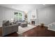 Bright living room featuring a fireplace, chandelier, and hardwood floors at 149 Archie Way, Woodstock, GA 30188