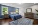 Bedroom showcasing blue accent wall, hardwood floors, and natural light at 149 Archie Way, Woodstock, GA 30188
