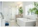 Elegant bathroom with a freestanding tub, glass shower, and modern fixtures at 2063 Wheaton Way, Sandy Springs, GA 30328