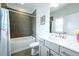 Well-lit bathroom featuring tile accents, a shower-tub combo, and modern vanity with ample counter space at 2063 Wheaton Way, Sandy Springs, GA 30328