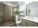 Modern bathroom featuring a glass-enclosed shower, a vanity with counter space, and neutral-toned tile accents at 2063 Wheaton Way, Sandy Springs, GA 30328