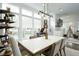 Elegant dining room with modern light fixtures, large windows, and stylish decor at 2063 Wheaton Way, Sandy Springs, GA 30328