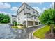 Modern condo building with a combination of siding and brick exterior, showcasing attached garages and bay windows at 2063 Wheaton Way, Sandy Springs, GA 30328