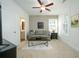 Cozy living room features neutral decor, ceiling fan, and comfortable seating area at 2063 Wheaton Way, Sandy Springs, GA 30328