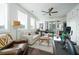 Bright living room with many windows features a ceiling fan and access to the outdoor patio at 2063 Wheaton Way, Sandy Springs, GA 30328