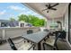 Covered outdoor patio area with ample seating and a view of the landscaped yard at 2063 Wheaton Way, Sandy Springs, GA 30328
