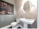 Chic powder room features a pedestal sink, round mirror, and artistic wallpaper at 2063 Wheaton Way, Sandy Springs, GA 30328