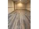 A finished basement featuring luxury vinyl flooring and a drop ceiling, ready for customization and use at 3261 Stonecreek Ct, Suwanee, GA 30024