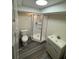 Bathroom featuring a modern glass shower, toilet, and vanity with sink, offering a clean and functional space at 3261 Stonecreek Ct, Suwanee, GA 30024