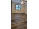 Bedroom with hardwood floors, ceiling fan, and window with blinds at 3261 Stonecreek Ct, Suwanee, GA 30024