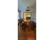 Cozy dining area with hardwood floors, modern lighting, and an open view to the living room at 3261 Stonecreek Ct, Suwanee, GA 30024