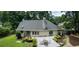 Aerial view showcasing a backyard with a well-maintained lawn, a deck, and a table with chairs at 3261 Stonecreek Ct, Suwanee, GA 30024