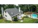 Aerial view showcasing a backyard with a well-maintained lawn, a deck, and a sparkling blue pool at 3261 Stonecreek Ct, Suwanee, GA 30024