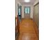 Inviting foyer featuring hardwood floors, a decorative front door, and a convenient coat closet at 3261 Stonecreek Ct, Suwanee, GA 30024