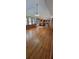 Bright living room featuring hardwood floors, a ceiling fan, and access to the kitchen at 3261 Stonecreek Ct, Suwanee, GA 30024