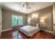 This cozy bedroom features hardwood floors and ample natural light at 3680 Milton Park Dr, Alpharetta, GA 30022
