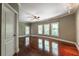 A spacious bedroom offers hardwood floors and abundant natural light at 3680 Milton Park Dr, Alpharetta, GA 30022
