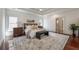 Main bedroom features large windows, hardwood floors, a sitting bench, and tray ceiling at 3680 Milton Park Dr, Alpharetta, GA 30022