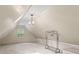 Finished attic with a chandelier, dormer window, and storage racks at 1789 Brandi Ln, Loganville, GA 30052