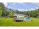Spacious backyard with a wooden fence features an above ground pool and a cozy fire pit at 1789 Brandi Ln, Loganville, GA 30052