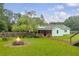 Backyard with a brick path, swing and inviting fire pit offers a perfect outdoor retreat at 1789 Brandi Ln, Loganville, GA 30052