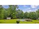Spacious backyard features an above ground pool with wooden deck, a fire pit, and a storage shed at 1789 Brandi Ln, Loganville, GA 30052