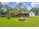 Backyard area featuring a fire pit with mature trees at 1789 Brandi Ln, Loganville, GA 30052
