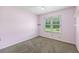 Cozy bedroom with neutral carpet, window, and closet space at 1789 Brandi Ln, Loganville, GA 30052
