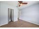 Light blue bedroom featuring a ceiling fan, carpet floors, and a closet with curtains at 1789 Brandi Ln, Loganville, GA 30052