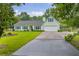 Charming light green single-story home with well-manicured lawn and a two-car garage at 1789 Brandi Ln, Loganville, GA 30052