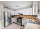 Updated kitchen with stainless steel appliances and light stone countertops at 1789 Brandi Ln, Loganville, GA 30052