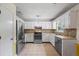 Stylish kitchen featuring stainless steel appliances, modern cabinets, and stone backsplash at 1789 Brandi Ln, Loganville, GA 30052