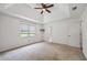 Bright main bedroom with a ceiling fan and ensuite bathroom at 1789 Brandi Ln, Loganville, GA 30052