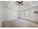 Spacious main bedroom with a ceiling fan, tray ceiling, and a large window at 1789 Brandi Ln, Loganville, GA 30052