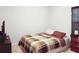Neutral bedroom featuring a plaid comforter, television and a window with blinds at 20 Sloane Ct, Covington, GA 30016